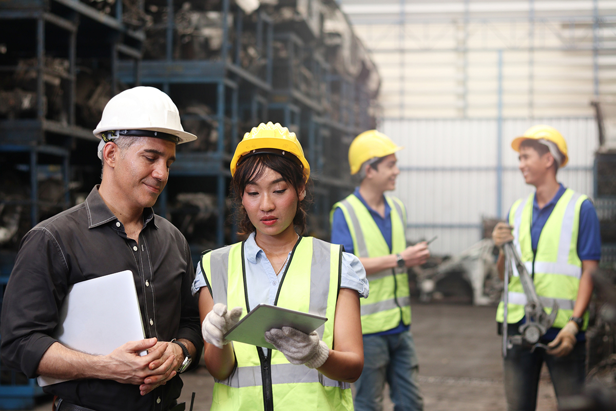 Young construction workers looking at an iPad and conversing